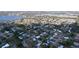 Aerial shot of a community next to a lake, featuring a variety of homes amid abundant trees at 1625 Avenue D Ne, Winter Haven, FL 33881