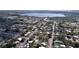 Scenic aerial view of a residential area near a lake, highlighting diverse homes and tree-lined streets at 1625 Avenue D Ne, Winter Haven, FL 33881