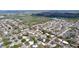 Expansive aerial view of a residential neighborhood with lush greenery, mature trees, and various housing styles at 1625 Avenue D Ne, Winter Haven, FL 33881