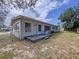 Cozy backyard with small deck is ideal for relaxing or entertaining with two chairs at 1625 Avenue D Ne, Winter Haven, FL 33881