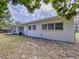 Exterior of home with a small back deck with chairs and well-maintained yard at 1625 Avenue D Ne, Winter Haven, FL 33881