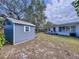 Backyard featuring a storage shed and a glimpse of the home with a small deck at 1625 Avenue D Ne, Winter Haven, FL 33881