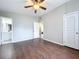 Open bedroom featuring wood floors, ceiling fan, closet, and access to bathroom at 1625 Avenue D Ne, Winter Haven, FL 33881