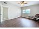 Bright bedroom featuring wood floors, ceiling fan, closet, and natural light at 1625 Avenue D Ne, Winter Haven, FL 33881