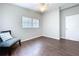 Neutral bedroom featuring gleaming wood floors, large window, and bright walls at 1625 Avenue D Ne, Winter Haven, FL 33881