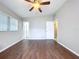 Open bedroom featuring wood floors, vaulted ceilings, and access to bathroom at 1625 Avenue D Ne, Winter Haven, FL 33881