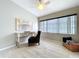 Neutral bedroom with a ceiling fan, desk, and a comfortable chair near a window at 1625 Avenue D Ne, Winter Haven, FL 33881