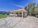 Charming home featuring a covered carport and a spacious concrete driveway at 1625 Avenue D Ne, Winter Haven, FL 33881