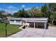 Aerial view of a charming home with a carport and a well-maintained lawn at 1625 Avenue D Ne, Winter Haven, FL 33881