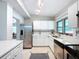 Modern kitchen featuring white cabinets, stainless steel appliances, and attractive backsplash detailing at 1625 Avenue D Ne, Winter Haven, FL 33881