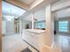 Bright kitchen island featuring modern white cabinets and countertops, open to the living area at 1625 Avenue D Ne, Winter Haven, FL 33881