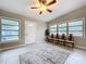 Sunlit living room boasts a large window array, neutral tile flooring and an open, airy feel at 1625 Avenue D Ne, Winter Haven, FL 33881