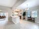 Bright living room with a partial view of the kitchen, featuring ceramic tile and access to the entryway at 1625 Avenue D Ne, Winter Haven, FL 33881