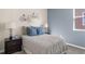 Cozy bedroom featuring decorative bicycle wall art, soft lighting, and neutral-toned bedding at 1952 Rider Rain Ln, Apopka, FL 32703