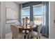 Bright dining area featuring a round wooden table, upholstered chairs, and large windows with sheer curtains at 267 Puma Loop, Groveland, FL 34736