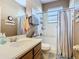 Bright bathroom featuring a shower-tub combo and a single sink vanity with a neutral color palette at 374 Villa Sorrento Cir, Haines City, FL 33844