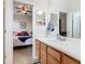 Bathroom with wood cabinets and view into a bedroom with ceiling fan at 374 Villa Sorrento Cir, Haines City, FL 33844