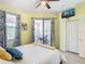 Bedroom with access to the pool area, ceiling fan, and tiled floors at 374 Villa Sorrento Cir, Haines City, FL 33844