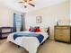 Bedroom featuring a ceiling fan, bed with decorative pillows, and a dresser at 374 Villa Sorrento Cir, Haines City, FL 33844