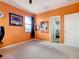 Bedroom featuring bright orange walls, carpet floors, and a closet at 374 Villa Sorrento Cir, Haines City, FL 33844