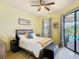 This light-filled bedroom features outdoor access to the pool area and a ceiling fan at 374 Villa Sorrento Cir, Haines City, FL 33844