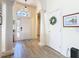 Bright foyer featuring wood-look tile flooring, decorative columns, and a striking arched entryway at 374 Villa Sorrento Cir, Haines City, FL 33844