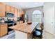 Bright kitchen boasts a butcher block island with seating and tile backsplash at 374 Villa Sorrento Cir, Haines City, FL 33844