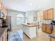 Open kitchen featuring stainless steel appliances, a central butcher block island and tile backsplash at 374 Villa Sorrento Cir, Haines City, FL 33844