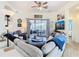 Inviting living room with a ceiling fan and sliding doors to a screened lanai for outdoor living at 374 Villa Sorrento Cir, Haines City, FL 33844