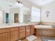 Bright main bathroom features a double vanity, a jetted tub, and separate shower at 374 Villa Sorrento Cir, Haines City, FL 33844