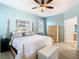 Calming main bedroom with blue walls, a four poster bed, ceiling fan, and a tiled floor at 374 Villa Sorrento Cir, Haines City, FL 33844