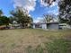 View of the home's backyard, surrounded by mature trees providing a serene outdoor space at 753 Avenue O Se, Winter Haven, FL 33880