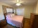 Bedroom with parquet floors and a pink bed, featuring a closet with sliding doors at 753 Avenue O Se, Winter Haven, FL 33880