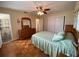 Cozy bedroom with wood floors, ceiling fan, dresser and a large closet at 753 Avenue O Se, Winter Haven, FL 33880