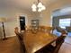 The dining room area has wooden table and chairs, next to a living room at 753 Avenue O Se, Winter Haven, FL 33880