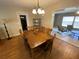 A dining room with wooden table and chairs, next to living room at 753 Avenue O Se, Winter Haven, FL 33880