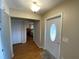 Foyer with hardwood floors and a white front door with oval glass insert at 753 Avenue O Se, Winter Haven, FL 33880