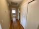 Hallway with closet space leads to a bathroom with a shower and tub at 753 Avenue O Se, Winter Haven, FL 33880