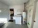 Bright laundry room features a utility sink, washer, and water heater at 753 Avenue O Se, Winter Haven, FL 33880