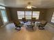 Cozy living room featuring a ceiling fan and four chairs around a center table at 753 Avenue O Se, Winter Haven, FL 33880