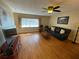 Open concept living room featuring bright picture window, sofa, and ceiling fan at 753 Avenue O Se, Winter Haven, FL 33880