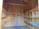 Spacious shed interior with wooden walls and shelving, providing ample storage solutions at 753 Avenue O Se, Winter Haven, FL 33880