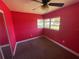 Bedroom with carpet, a ceiling fan, and a window for natural light at 100 High St, Winter Haven, FL 33880