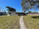 Charming single-story home with a walkway leading to the front entrance at 100 High St, Winter Haven, FL 33880