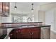 Kitchen featuring dark wood cabinets, stainless steel appliances, and a breakfast bar with pendant lighting at 101 S Eola Dr # 813, Orlando, FL 32801