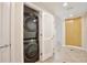 Hallway view showing stacked Samsung washer and dryer in a closet with tile flooring at 101 S Eola Dr # 813, Orlando, FL 32801