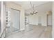 Bright and airy living room with hardwood floors, sliding glass doors, and modern chandelier at 101 S Eola Dr # 813, Orlando, FL 32801