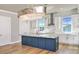 Contemporary kitchen with white cabinets, marble countertops, stainless steel appliances, and a striking chandelier at 15 Marden Dr, Ormond Beach, FL 32176