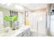 Bright bathroom featuring double vanity, a glass-enclosed shower, and stylish fixtures at 5888 Meditation Dr, Clermont, FL 34714