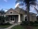 Charming single-story home with a covered front porch and lush landscaping at 706 Lake Tarpon Way, Groveland, FL 34736